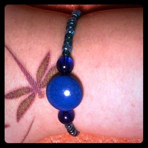 Homemade blue bracelet with a oval blue accent.